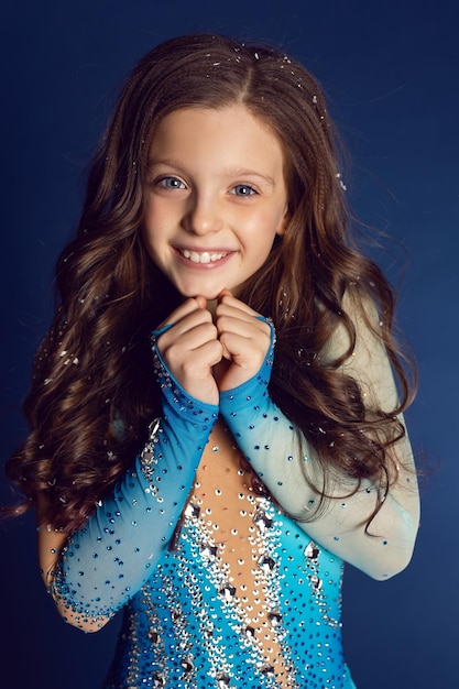 Girl in blue lycra dress with rhinestones for figure skating