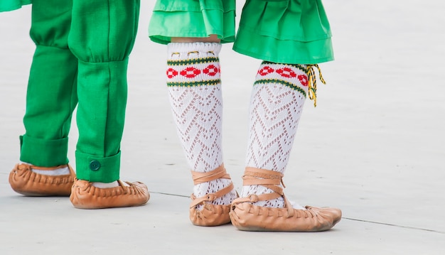 A girl and boy dance in a folk suit,