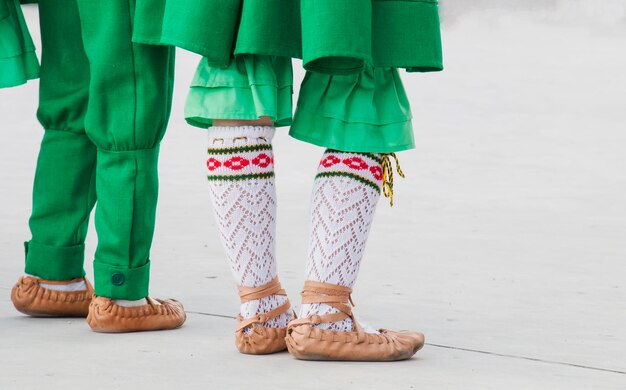 A girl and boy dance in a folk suit