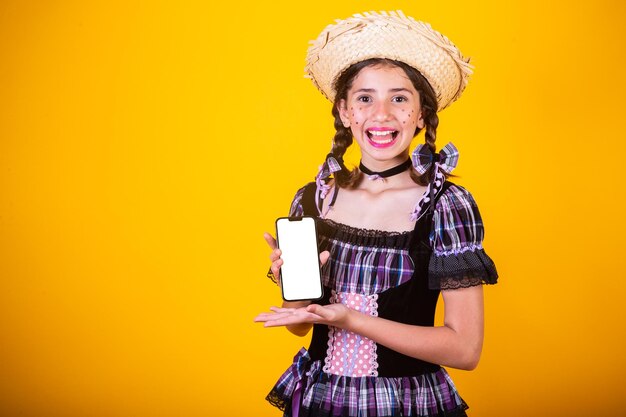 Girl brazilian with clothes from festa junina arraial festa de sao joao horizontal portrait with smartphone