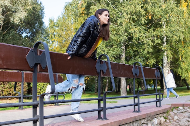 Girl on the bridge in the autumn park