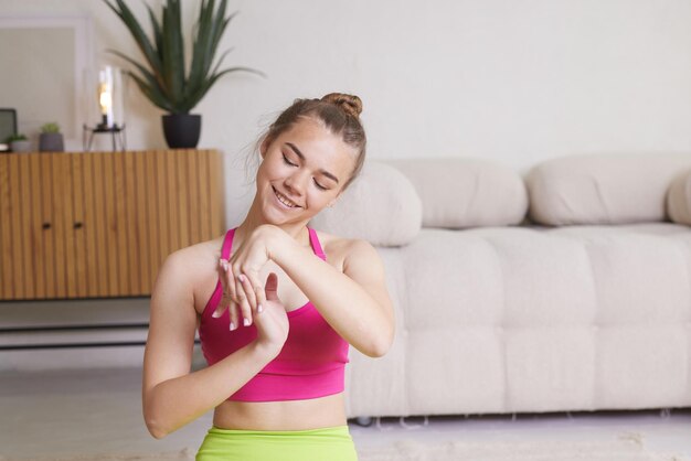 Girl in bright sportswear goes in for sports at home