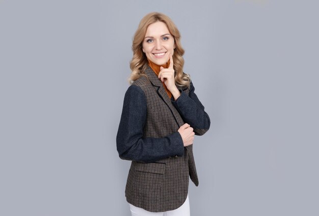 girl in british jacket. british fashion style. smiling businesswoman in english clothes on grey background. cheerful blonde woman in jacket. female beauty and fashion. business casual style.