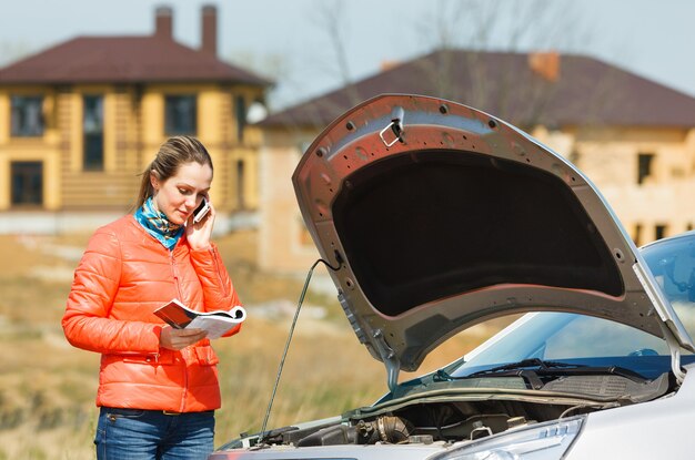 Girl broken car with open hood call  service for help