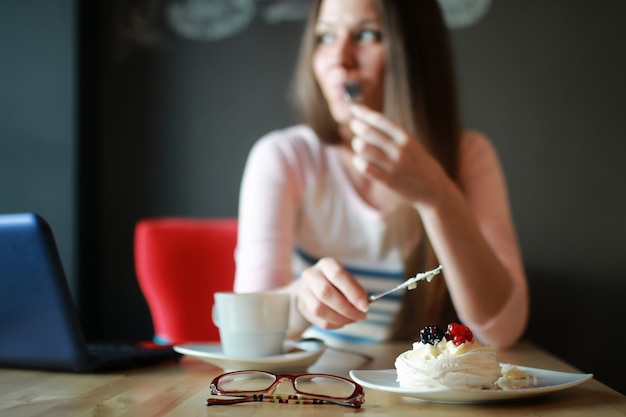 Girl in a cafe for a cup of coffee with the notebook