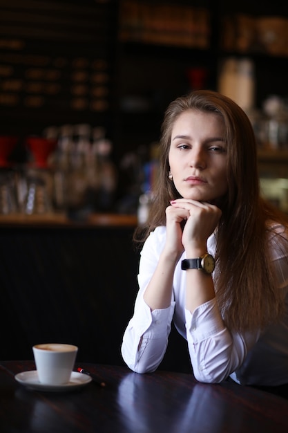 The girl in the cafe is having breakfast in paris