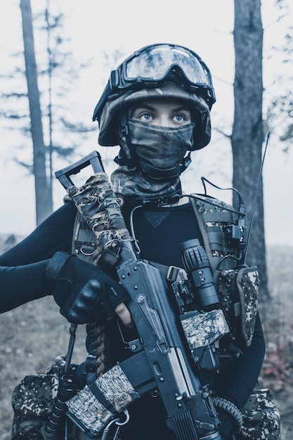 Girl in camouflage with a weapon