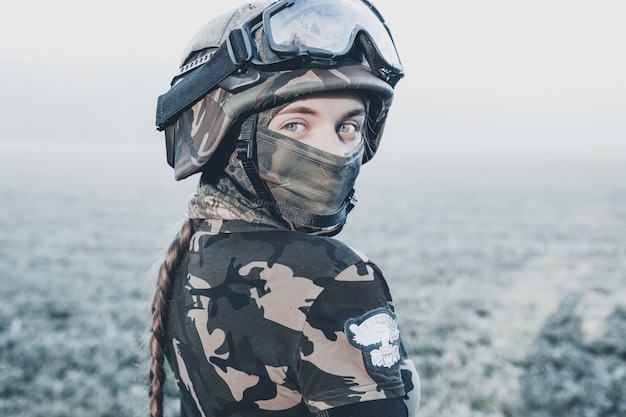 Girl in camouflage with a weapon