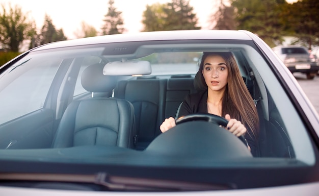 The girl in the car is in a traffic jam.