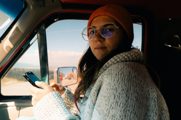 girl in a car with a phone in her hands