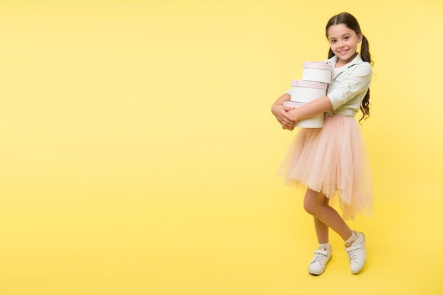 Girl carries pile boxes Save money shopping sale season Back to school season great time to teach budgeting basics children Prepare for school season buy supplies stationery clothes in advance