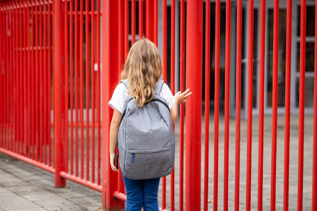 Girl carrying backpack and going to school