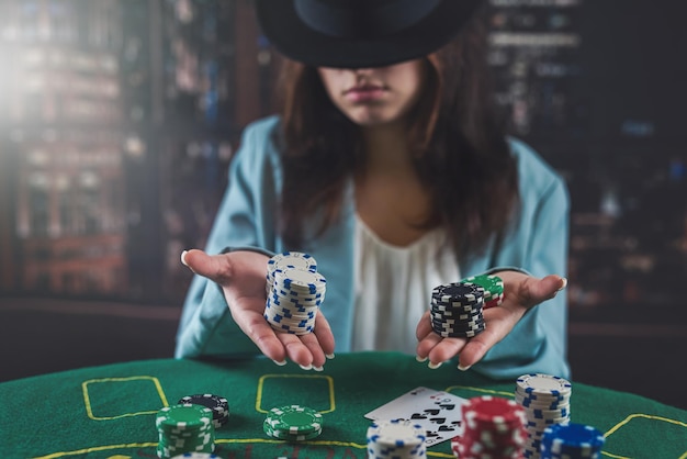 Girl in a casino plays poker with the confidence of winning the game poker woman with cards