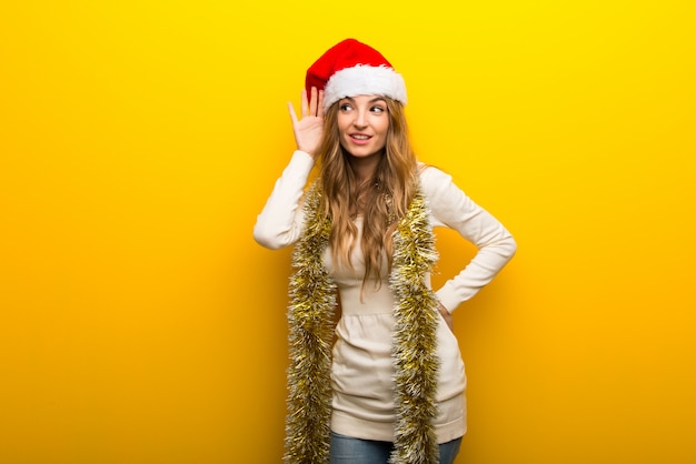 Girl celebrating the christmas holidays on yellow background