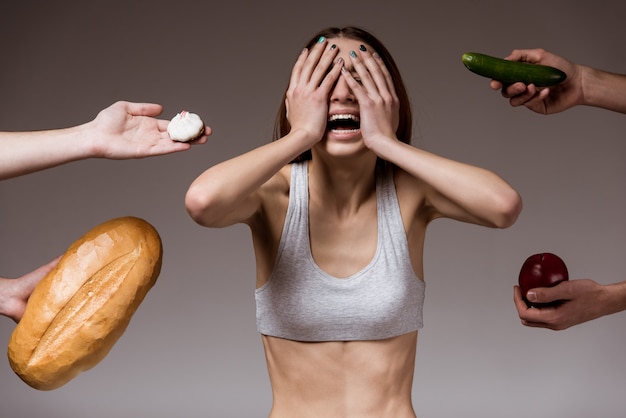 Girl in center of photo refuses food.