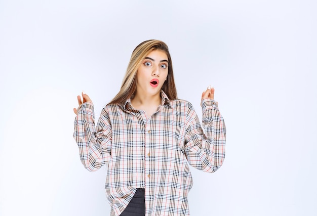 Girl in checked shirt showing ok hand sign