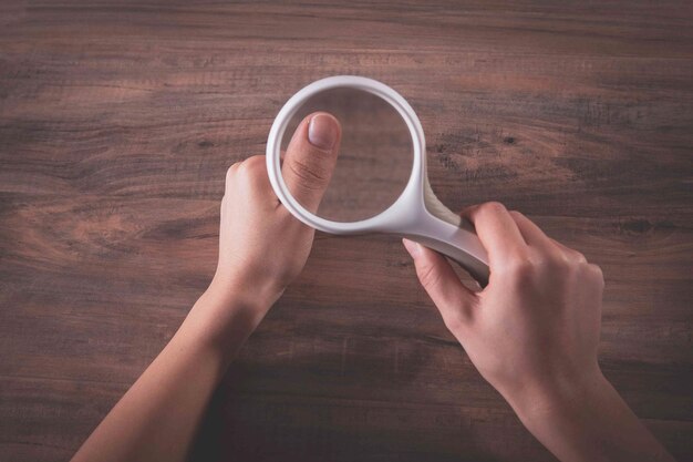 Girl checks nails with a magnifying glass