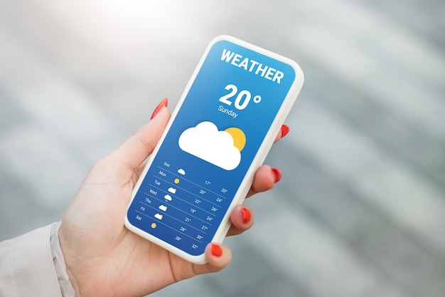 the girl checks the weather forecast in a mobile application