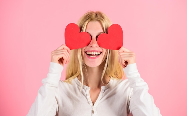 Girl cheerful fall in love Girl hold heart symbol love and romantic pink background Love is blind Valentines day has traditionally been seen as more significant for women Woman celebrate love