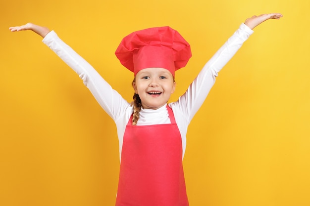 写真 女の子のシェフが手を上げた