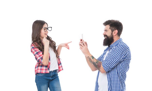 Girl child daughter with prop glasses posing for bearded man father taking photo with phone family