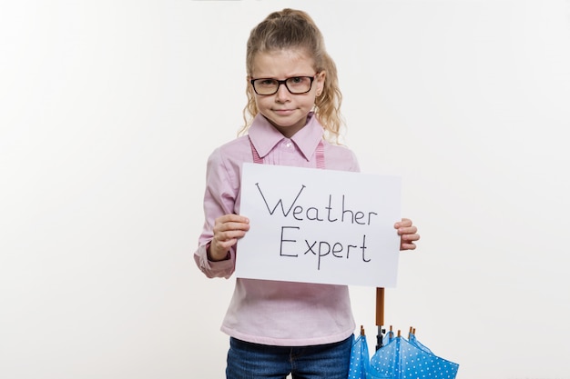 Girl child holding piece of paper with a word WEATHER EXPERT