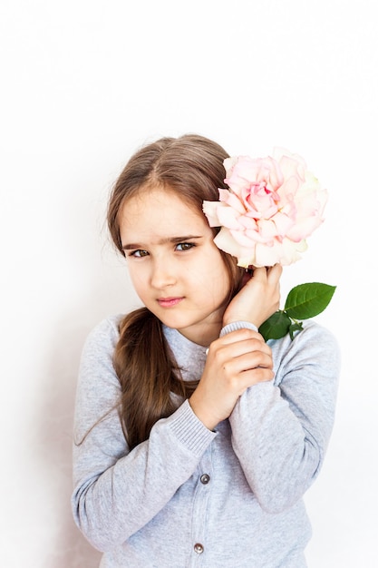 Girl, child holding a rose at the face, emotions, gift, children, holiday