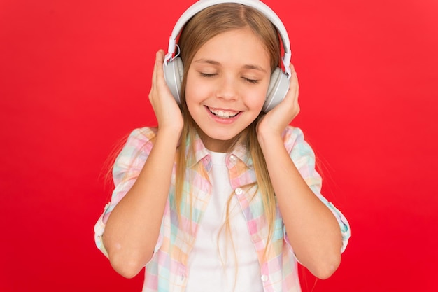 Girl child listen music modern headphones get music account\
subscription enjoy music concept music always with me little girl\
listen song headphones online radio station channel leisure\
concept