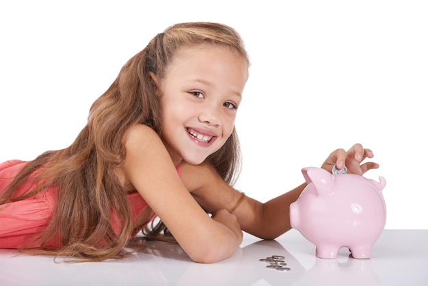 Photo girl child piggy bank and coins for portrait studio and pride with smile for investing by white background kid container or animal toys with relax for money cash or happy for financial education