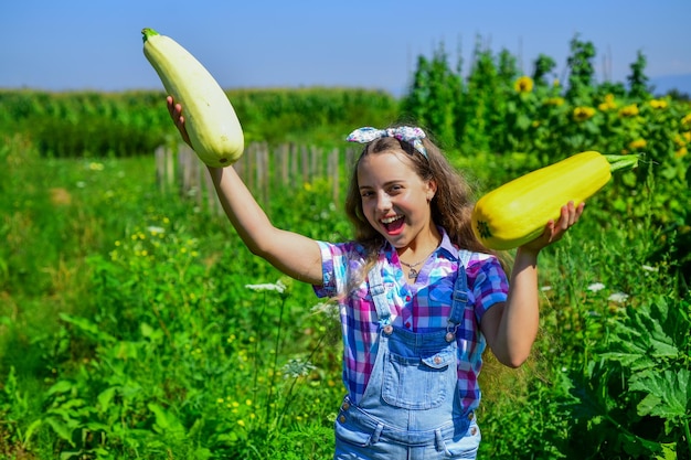 Girl child small farmer proud with harvest healthy food