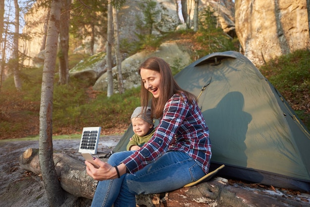 Girl and child take a selfie on mobile phone at background of te