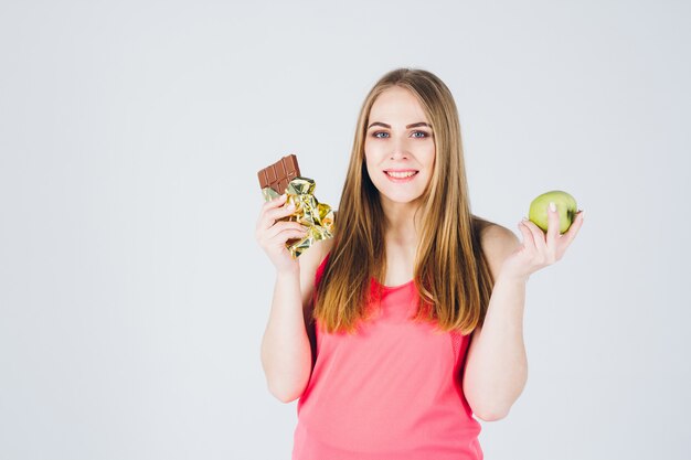 Girl chooses between Apple and chocolate