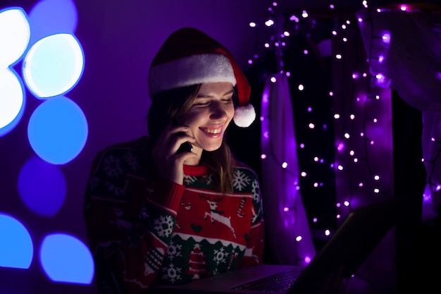 Girl in christmas clothes talking on the phone