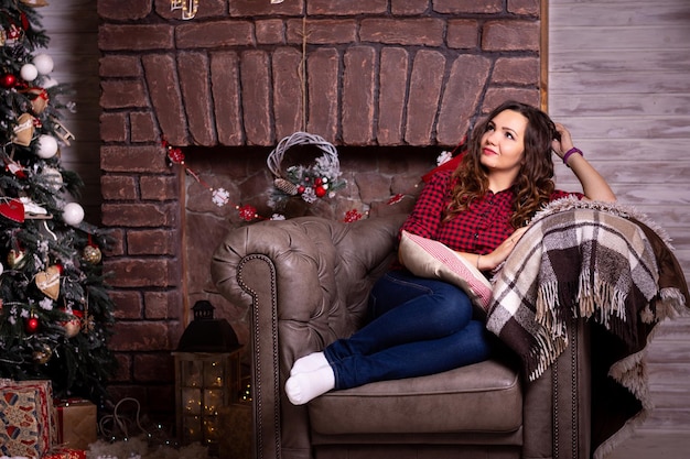 Girl in Christmas Happy cheerful woman celebrating new year with gifts near Christmas tree