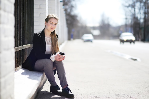 Girl in the city park for a walk casual clothes