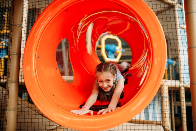 Girl climbing the maze in children game center