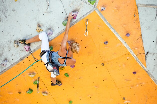 Girl climbing up the wall