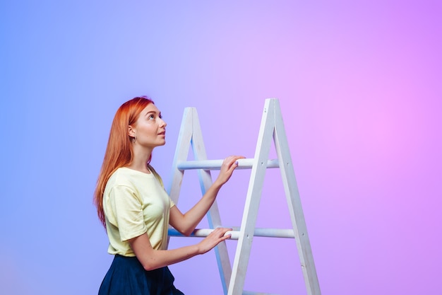 The girl climbs the ladder