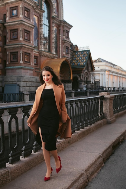 Photo girl in coat in the street at sunrise