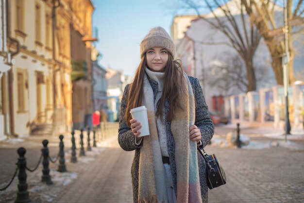 Girl in a coat with coffee