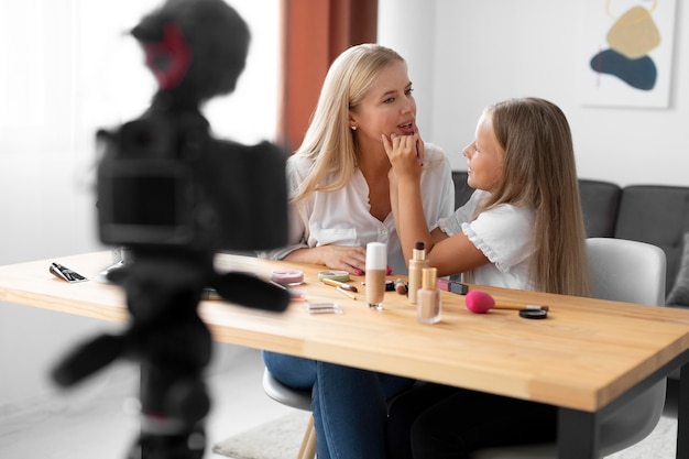 Photo girl contouring woman's lips medium shot