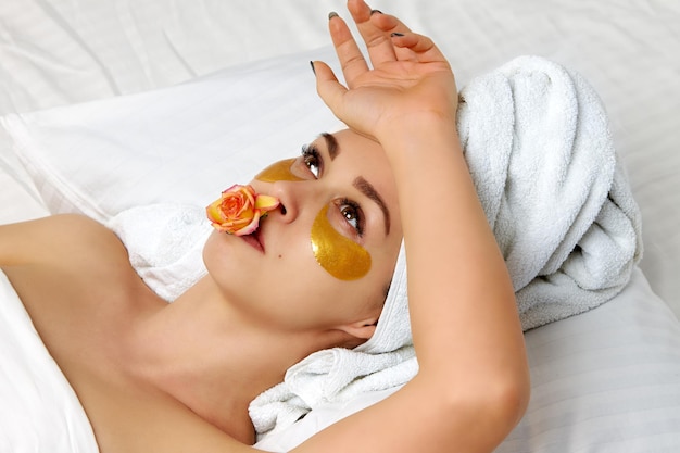 A girl in a cosmetic mask under her eyes relaxes