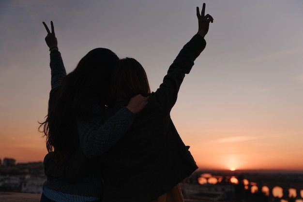 Girl couple celebrating love on a sunset