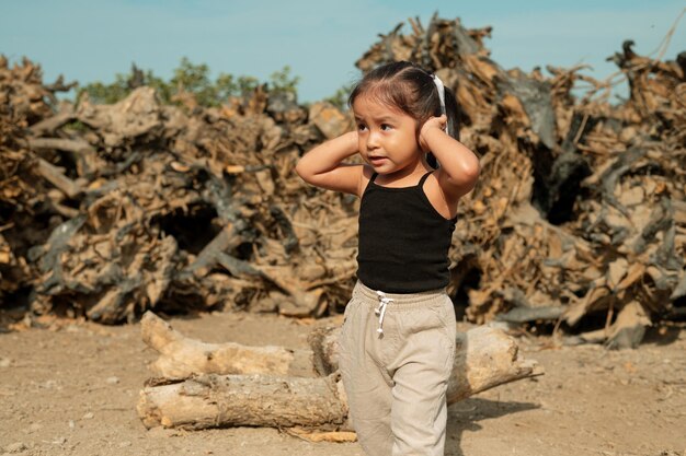 Photo girl covers her ears due to environmental pollution