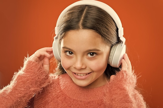 Girl cute little child wear headphones listen music kid listen\
music orange background recommended music based on initial interest\
tell me what you listen to and i will tell you who you are