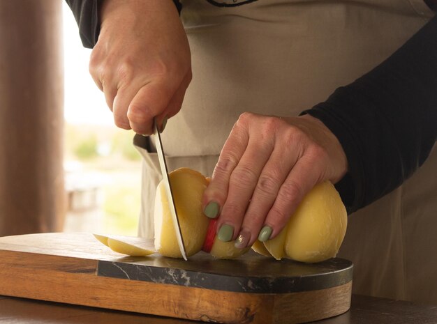 girl cuts cheese with a knife