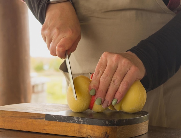 girl cuts cheese with a knife