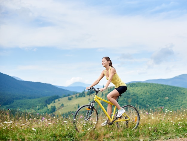 Girl cyclist riding on mountain bike