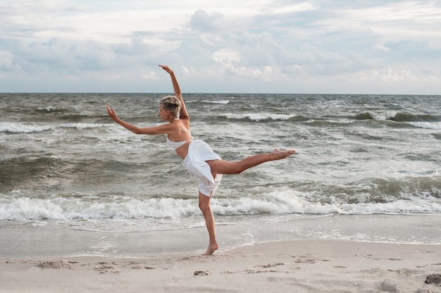 The girl dances on the beach