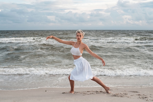 The girl dances on the beach